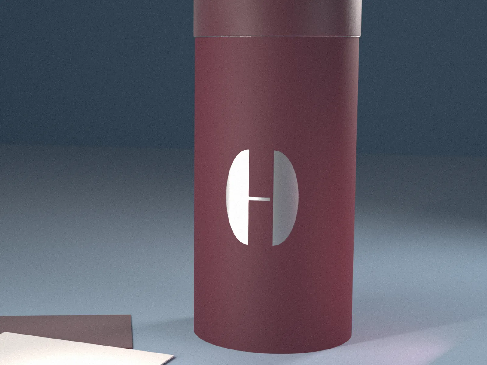 Burgundy HUSH tube with a silver-foil H on a dusty blue sweep